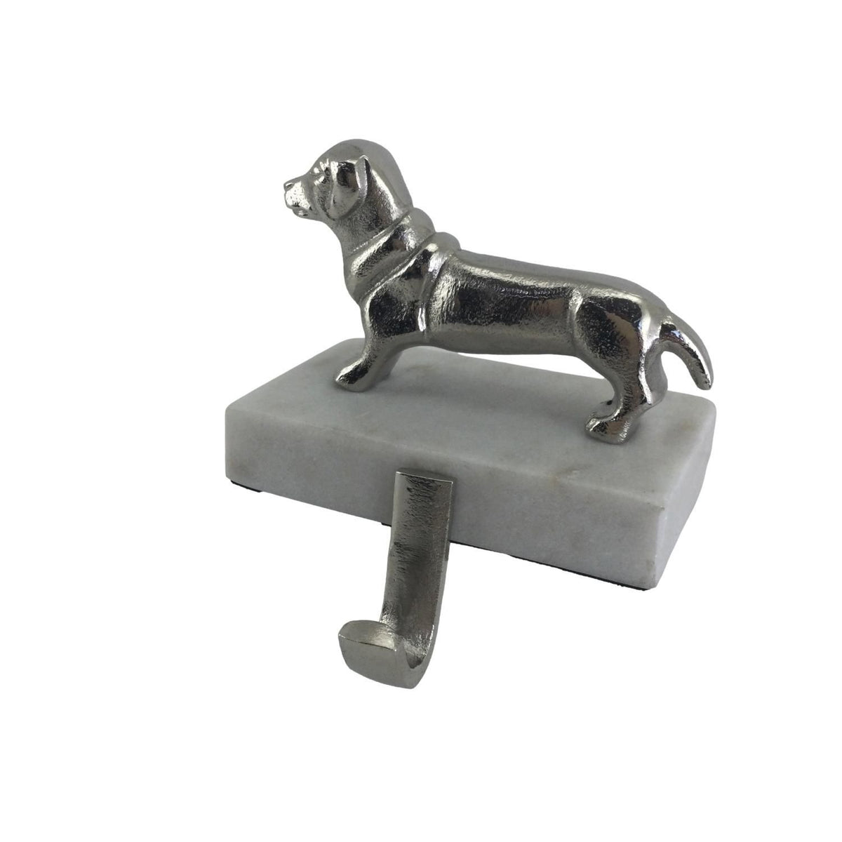 A sausage dog ornament attached to a block with hook for hanging Christmas stockings